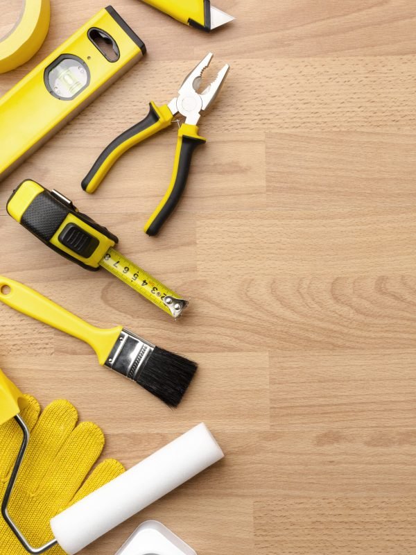 yellow-repair-kit-wooden-background yellow-repair-kit-wooden-background